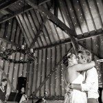 Wedding DJ and live entertainment provider at Lillibrooke Manor luxury Berkshire barn wedding venue - couple embrace whilst band play live