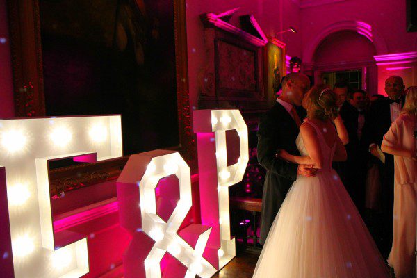 Couple kiss by light up letters In & Out club