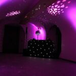 Wedding DJ at Queens House luxury wedding venue in London - purple ambient light and DJ booth with mirror ball