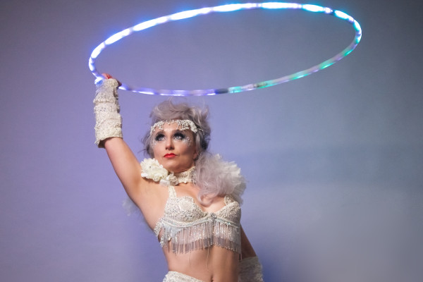 Burlesque performer Ana The Hulagan holds her LED hoop a unique booking for any event including weddings and corporate parties