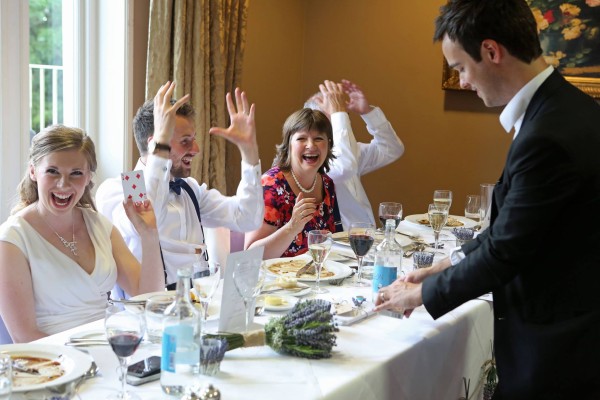 Delighted Wedding guests enjoy Magician
