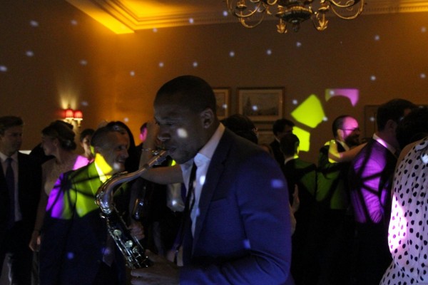 Saxophonist performs to dancing Wedding guests