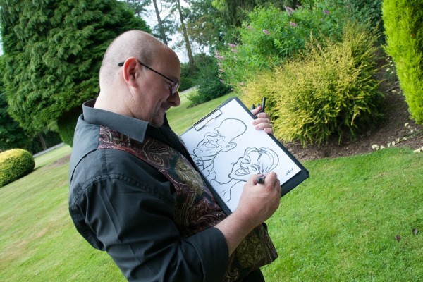 Artist sketches caricatures of the Bride and Groom during Wedding