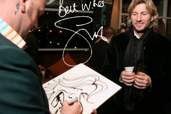 George G Williams draws a caricature of Robbie Savage at a corporate event