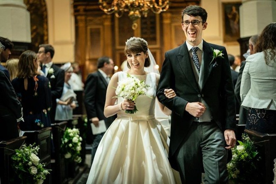 Wedding DJ at Stationers' Hall luxury wedding venue in London - Happy bride and groom walk down the aisle