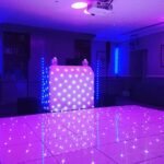 Wedding DJ at Cliveden House luxury Berkshire wedding venue - white LED dancefloor and white DJ booth setup