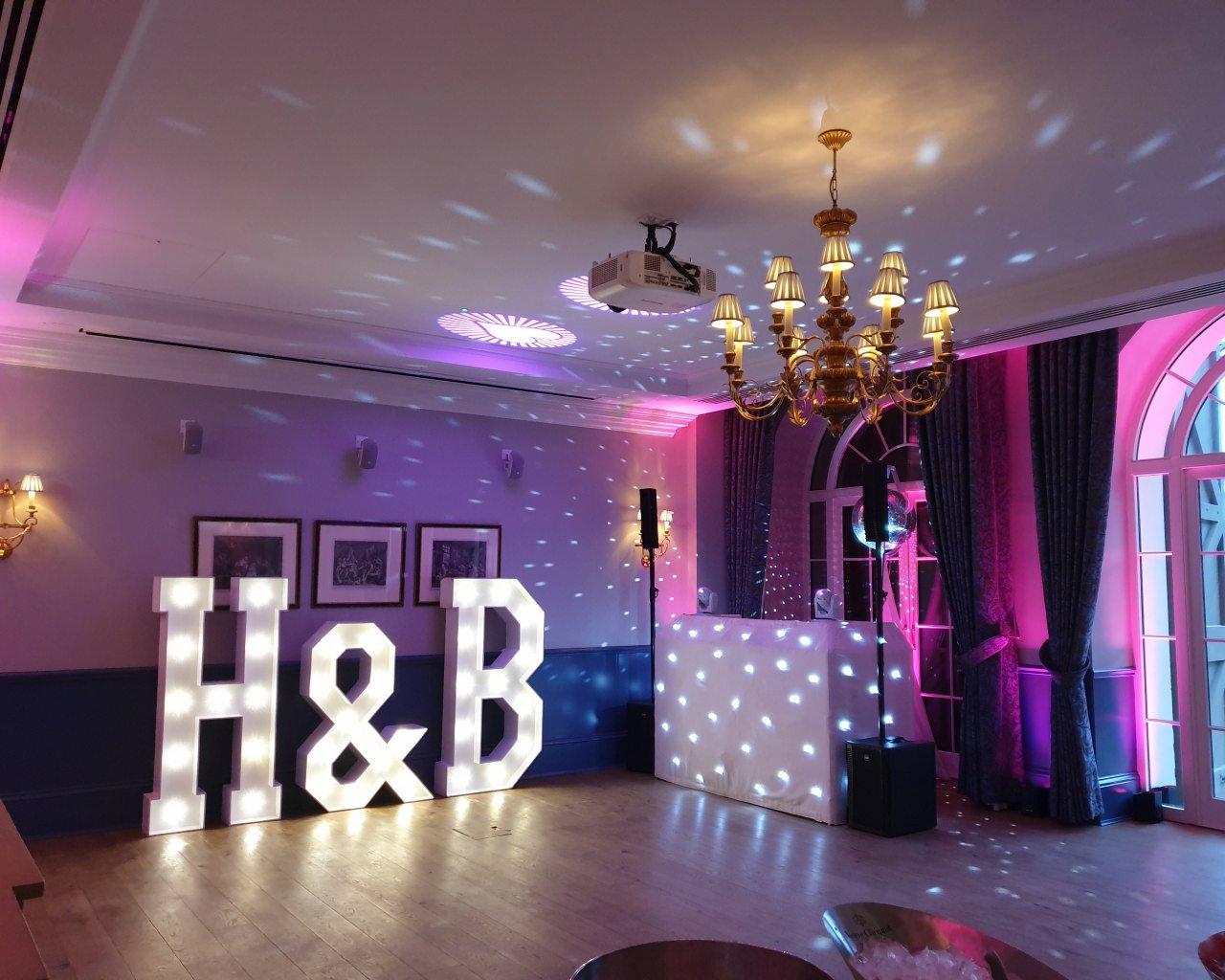 Wedding DJ at Cliveden House luxury Berkshire wedding venue - white DJ booth with large LED letters