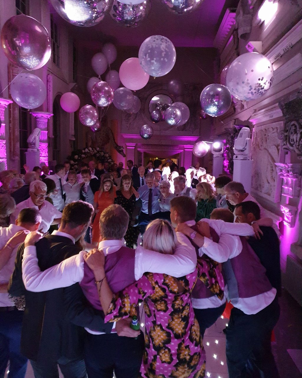 Aynhoe Park wedding guest come together at the end of the wedding disco to celebrate the couple