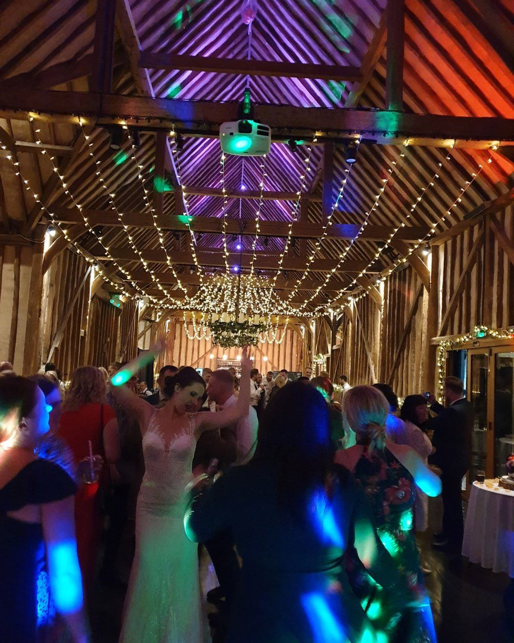 Wedding DJ at Lillibrooke Manor luxury Berkshire barn wedding venue - bride on the dancefloor during wedding reception party 