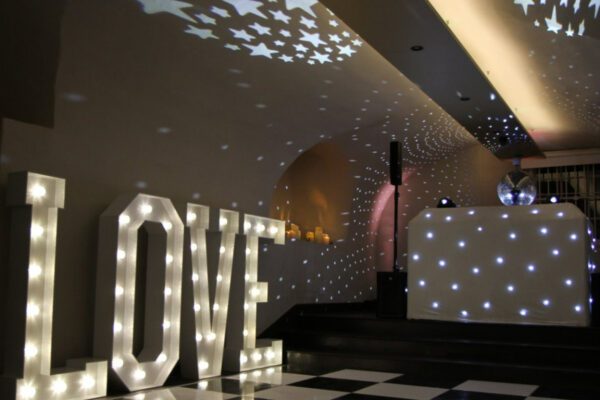 Wedding DJ playing at Queen's House in Greenwich, London with large light up letters and LED DJ booth