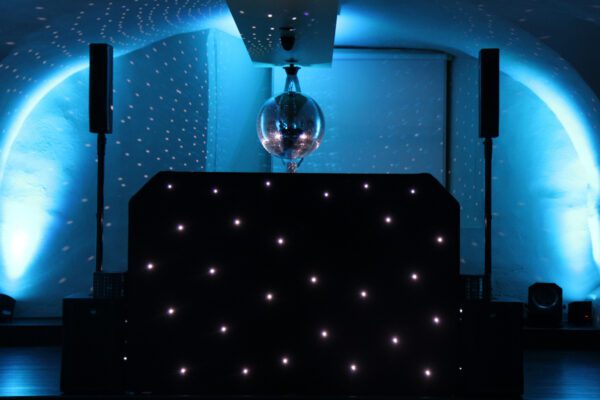 Wedding DJ playing at Queen's House in Greenwich, London - black LED DJ booth setup with mirror ball