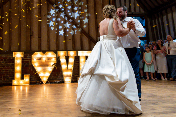 Happy couple dance to wedding DJ at Lillibrooke Manor barn wedding venue in Berkshire