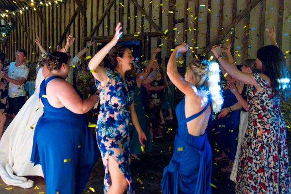 Guests dance to wedding DJ at Lillibrooke Manor barn wedding venue in Berkshire