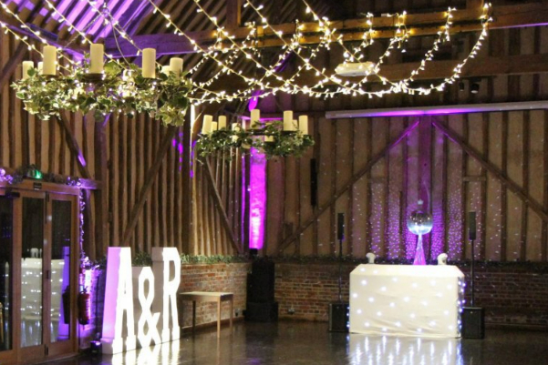 Wedding DJ setup with fairy lights at Lillibrooke Manor converted luxury barn wedding venue in Berkshire