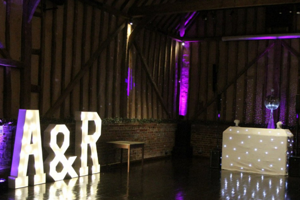 Wedding DJ both and large LED light up letters at Lillibrooke Manor barn wedding venue in Berkshire