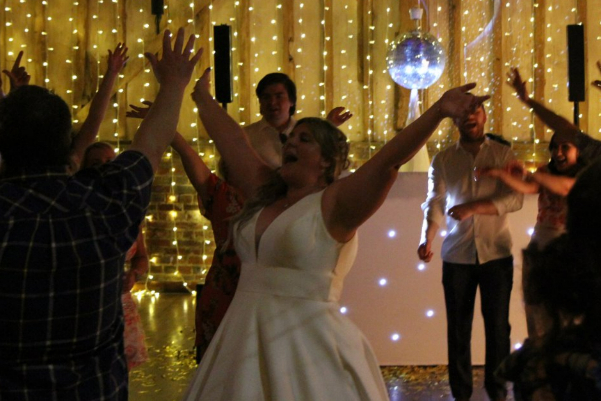 Wedding DJ at Lillibrooke Manor barn wedding venue in Berkshire - bride dancing in front of LED DJ booth