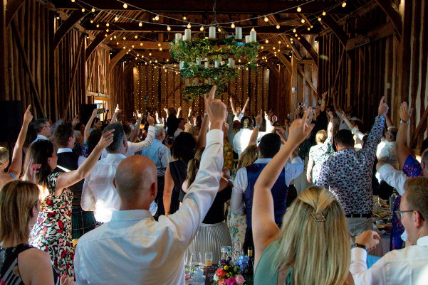 Wedding DJ at Lillibrooke Manor barn wedding venue in Berkshire - wedding guests cheer happy couple