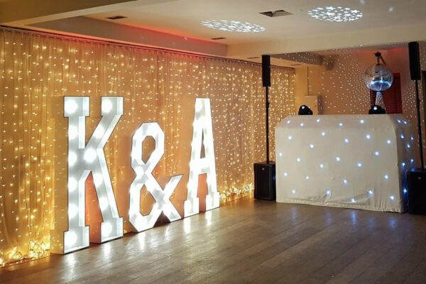 Wedding DJ at Stoke Place wedding venue in Buckinghamshire with bride and grooms initials in light up letters