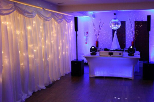 Wedding DJ at Stoke Place wedding venue in Buckinghamshire - lighting options and DJ booth setup with disco ball