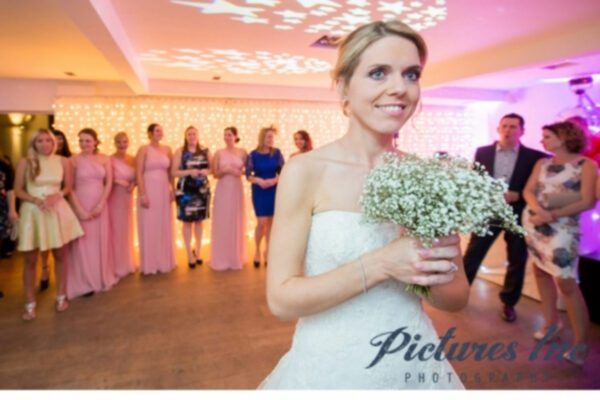 Wedding DJ at Stoke Place wedding venue in Buckinghamshire - bride about to throw her bouquet