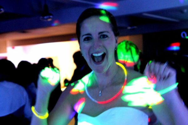 Wedding DJ at Stoke Place wedding venue in Buckinghamshire - bride celebrating with glow sticks 