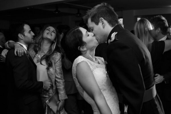 Wedding DJ at Stoke Place wedding venue in Buckinghamshire - couple share a kiss on the dance floor