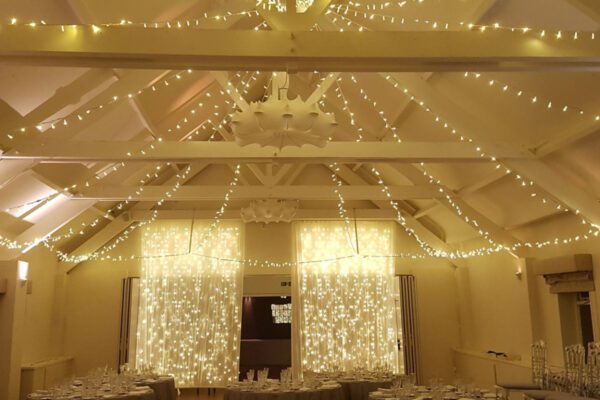 Wedding DJ at Stoke Place wedding venue in Buckinghamshire - ceiling lighting and fairy light decor
