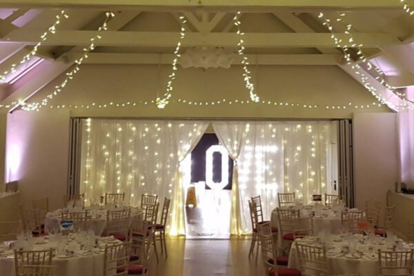 Wedding DJ at Stoke Place wedding venue in Buckinghamshire - fairy lights, light up letters and neutral decor for ceremony