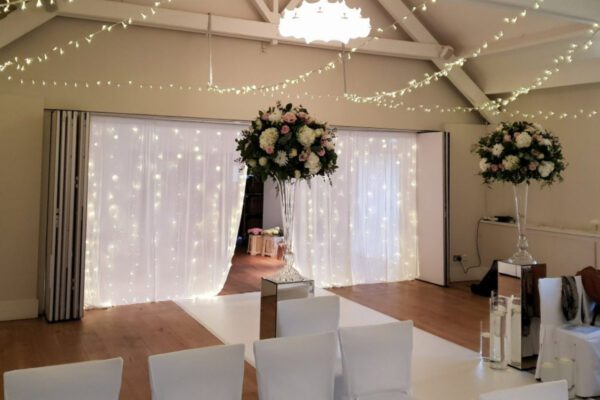 Wedding DJ at Stoke Place wedding venue in Buckinghamshire - seating and fairy light curtains