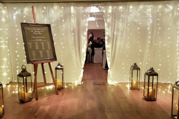 Wedding DJ at Stoke Place wedding venue in Buckinghamshire - fairy light curtains and decorative ideas