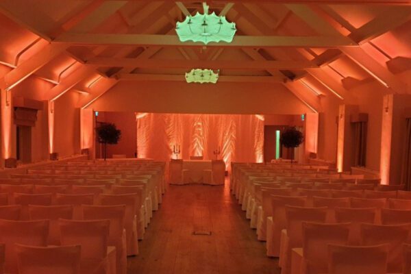 Wedding DJ at Stoke Place wedding venue in Buckinghamshire - orange mood lighting for ceremony