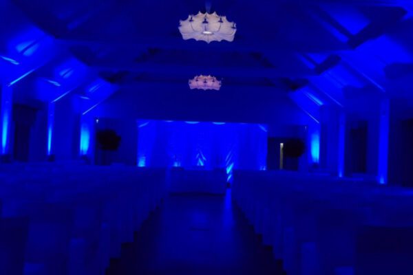 Wedding DJ at Stoke Place wedding venue in Buckinghamshire - blue lighting for barn ceremony