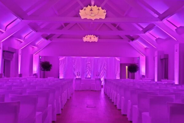 Wedding DJ at Stoke Place wedding venue in Buckinghamshire - purple mood lighting in barn setting