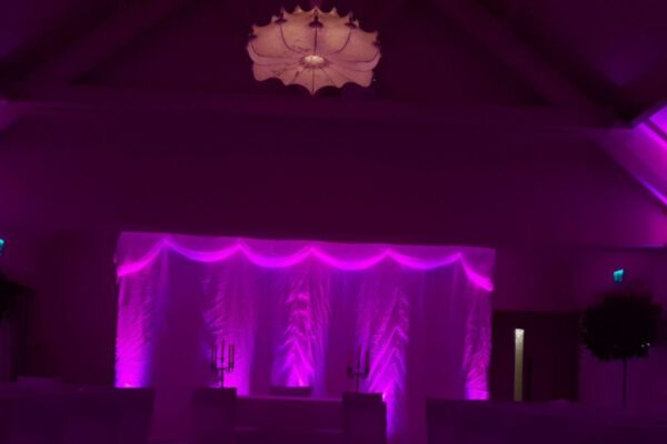 Wedding DJ at Stoke Place wedding venue in Buckinghamshire - purple mood lighting in converted barn