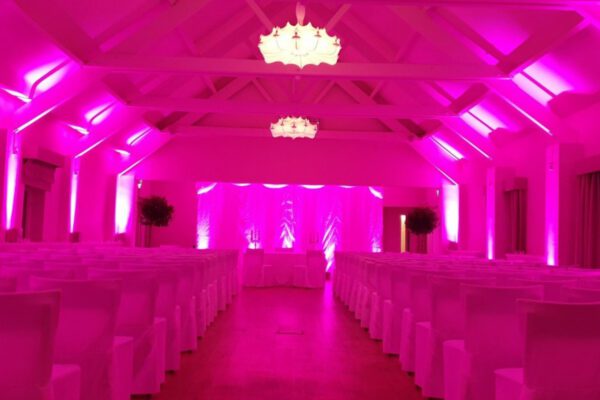 Wedding DJ at Stoke Place wedding venue in Buckinghamshire - pink mood lighting for barn