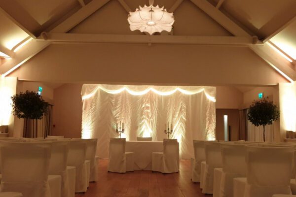 Wedding DJ at Stoke Place wedding venue in Buckinghamshire - neutral, warm mood lighting for wedding ceremony