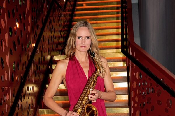 Heather sax player to book with DJ on stairs in red dress