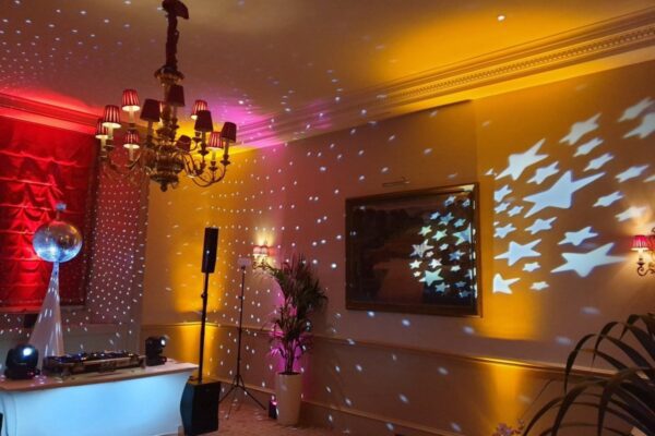 Wedding DJ at Cliveden House, Berkshire - DJ booth with light projections and mirror ball