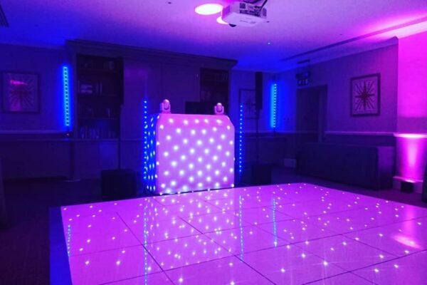 Wedding DJ at Cliveden House, Berkshire - pink and purple mood lighting, DJ booth and LED dance floor