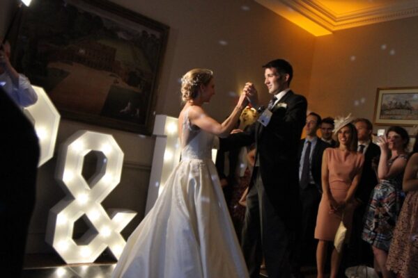 Wedding DJ at Cliveden House, Berkshire - couple dancing in front of their initials in LED letters