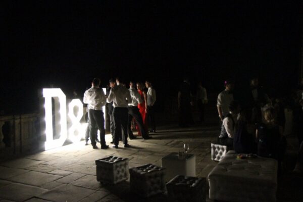 Wedding DJ at Cliveden House, Berkshire - guests standing in front of large LED letters 