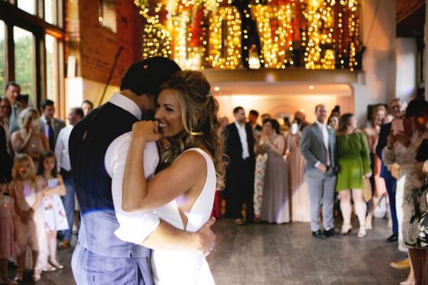 Wedding DJ at luxury Northamptonshire wedding venue Dodmoor House - bride and grooms first dance with illuminated LOVE letters