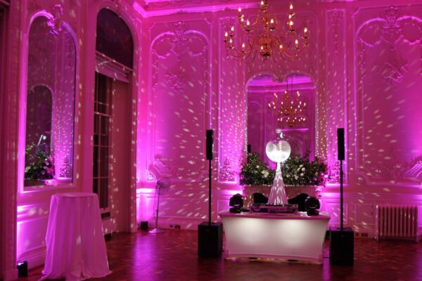 Wedding DJ at luxury London wedding venue 10-11 Carlton House Terrace - DJ booth with mirror ball and pink mood lighting