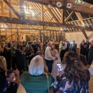 A newly married couple dancing their official first dance to the song played by their wedding DJ.