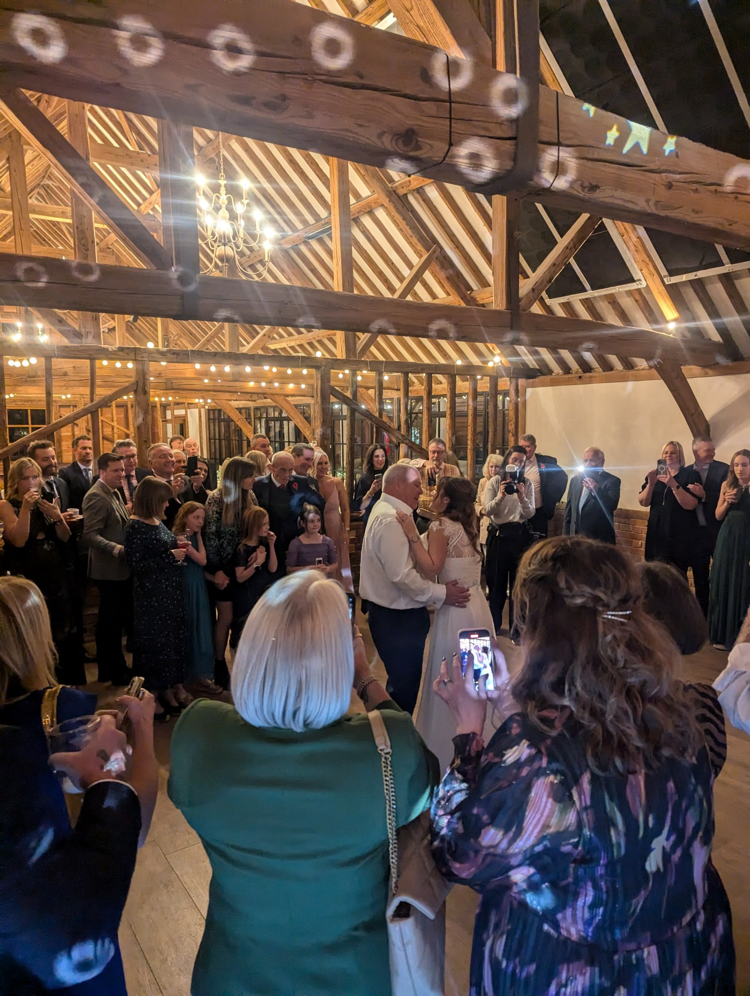 A newly married couple dancing their official first dance to the song played by their wedding DJ.