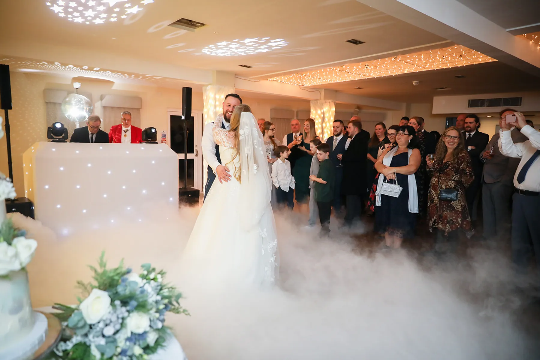 A bride and groom share their first dance on a